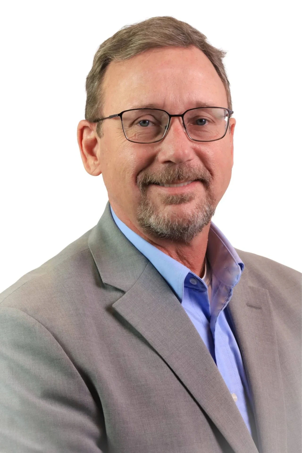 Business headshot of a man in a grey suit jacket